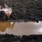 A boy drinks water from a pond in Bule Duba village in the outskirts of Moyale, near the edge of Oroma and Somali regions of Ethiopia