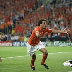 GERMAN PLAYER CHRISTIAN WORNS HOLDS ON WHILE DUTCH PLAYER RUUD VAN NISTELROOY SCORES